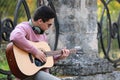 Young man playing guitar outdoors Royalty Free Stock Photo