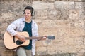 Young man playing guitar outdoors Royalty Free Stock Photo