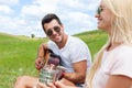 Young man playing guitar to his girl summer day couple Royalty Free Stock Photo