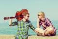 Young man playing guitar to his girlfriend outdoor Royalty Free Stock Photo