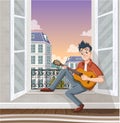 Young man playing guitar in the window. Music in the city. Royalty Free Stock Photo