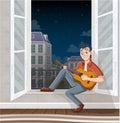 Young man playing guitar in the window. Music in the city. Royalty Free Stock Photo