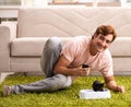 Young man playing with kitten at home Royalty Free Stock Photo