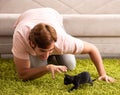 Young man playing with kitten at home Royalty Free Stock Photo