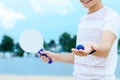 Young man playing with matkot rackets