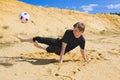 Young man playing soccer on beach Royalty Free Stock Photo