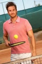 Young man playing tennis smiling Royalty Free Stock Photo