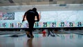 Young man playing tenpin bowling and throwing bowling ball at the pins in the lane at Wangsa