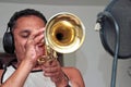 Young man playing trumpet in studio Royalty Free Stock Photo