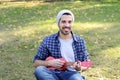 Young man playing the ukelele in a park. Royalty Free Stock Photo