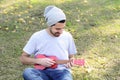 Young man playing the ukelele in a park. Royalty Free Stock Photo