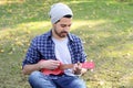 Young man playing the ukelele in a park. Royalty Free Stock Photo