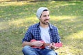 Young man playing the ukelele in a park. Royalty Free Stock Photo