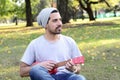 Young man playing the ukelele in a park. Royalty Free Stock Photo