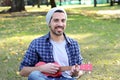 Young man playing the ukelele in a park. Royalty Free Stock Photo