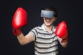 Young man is playing video game and is boxing with 3D virtual reality glasses