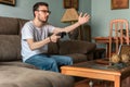 Young man playing video game holding wireless controller