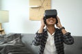 Man playing video games with virtual reality headset  in living room. Royalty Free Stock Photo