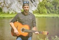 A young man plays an acoustic guitar outdoors Royalty Free Stock Photo