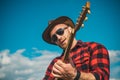 Young man plays guitar at sky. Royalty Free Stock Photo