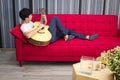 The young man plays the guitar to sing for a relaxing vacation Royalty Free Stock Photo