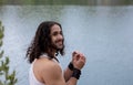 Young Man plays the harmonica alone outdoor near the lake Royalty Free Stock Photo