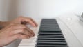 The young man plays a piano. Close up oh his hands Royalty Free Stock Photo