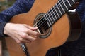 Young man plays spanish guitar close up