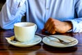 Young man after a pleasant tea party resting and talking on the phone in a cafe. business lunch, business meetings