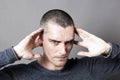 Young man plugging ears to avoid listening to problems Royalty Free Stock Photo