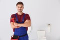 Young man with plumber wrench and toilet bowl