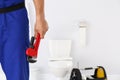 Young man with plumber wrench and toilet bowl Royalty Free Stock Photo