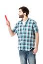 Young man pointing with big red pencil. Royalty Free Stock Photo