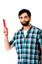 Young man pointing with big red pencil. Royalty Free Stock Photo