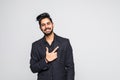 Young indian man pointing at something interesting on a white background Royalty Free Stock Photo