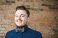 Young man with pompadour haircut, dressed in blue shirt with a laughing face. real photo hair for barbershop