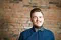 Young man with pompadour haircut, dressed in blue shirt with a smile face. real photo hair for barbershop