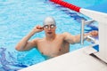 Young man in a pool - go to start swimming. backstroke during