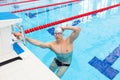 Young man in a pool - go to start swimming. backstroke during