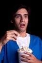 Young man, with popcorn watching