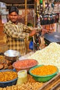 Young man popping popcorn at Kinari Bazaar in Agra, Uttar Pradesh, India