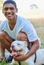 Young man, portrait and dog on lawn with happiness, playing with pitbull for pet love and fun outdoor. Adoption, foster Royalty Free Stock Photo