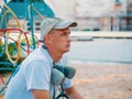 Young man portrait. Graffiti artist with protective mask sitting and looking to his picture Royalty Free Stock Photo