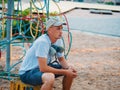 Young man portrait. Graffiti artist with protective mask sitting and looking to his picture. Royalty Free Stock Photo