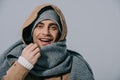 Young man posing in hat, scarf and coat, isolated on grey Royalty Free Stock Photo