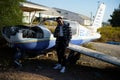 Young man posing near a crashed aircraft Royalty Free Stock Photo