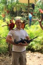 Young man posing with several exotic birds,Jungle Island,Miami,2014