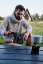 Young man pours coffee from a geyser coffee maker Royalty Free Stock Photo