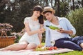 Young man pours to woman wine in a glass