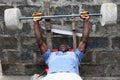 A young man practices weightlifting in Accra, Ghana